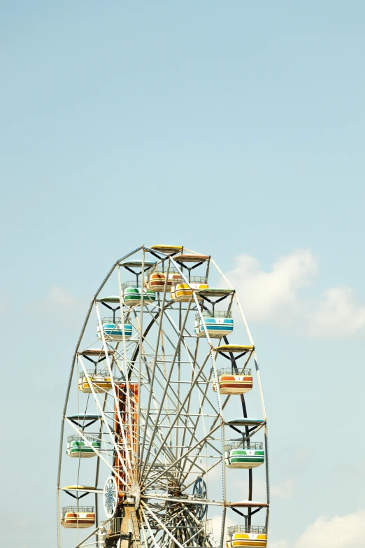 a amut park ferris wheel in front of the sky