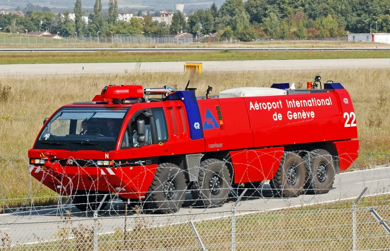 a large red truck on the side of the road