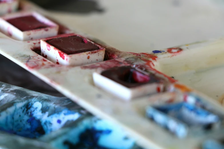 red and white pieces of dessert sitting on top of a plastic container