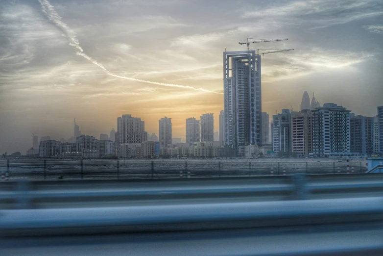 skyline in the city with airplane contrails in the sky