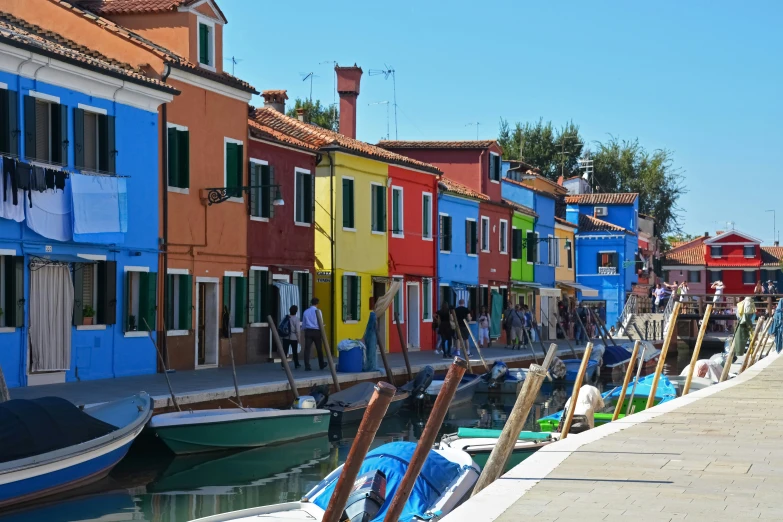 a small row of buildings with boat parked next to each other