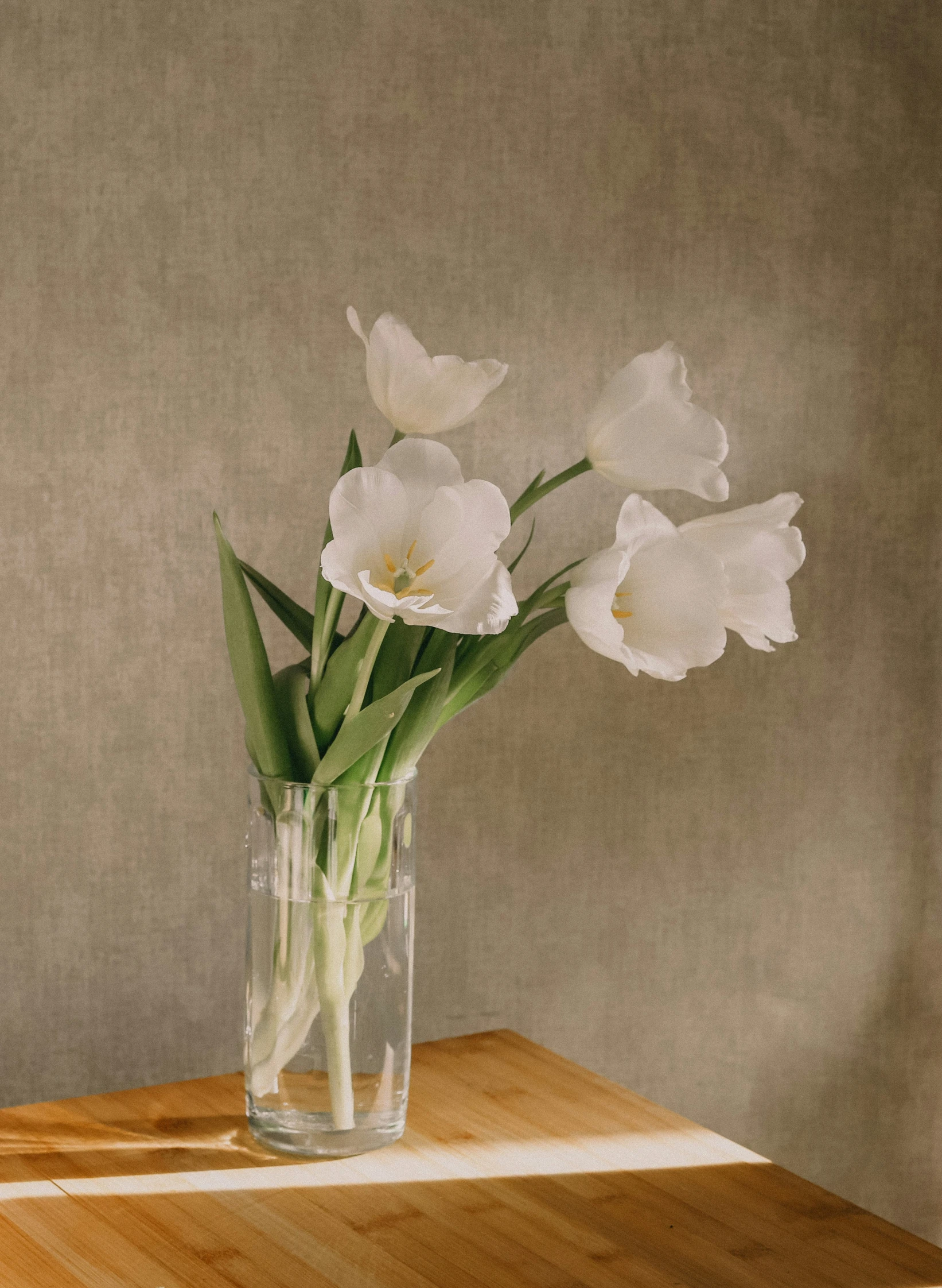 the flowers are in the glass vase on the table