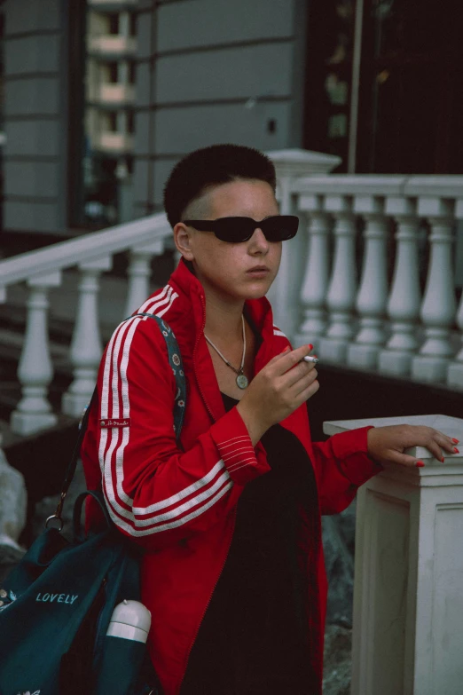 a woman smoking a cigarette, and walking down the street