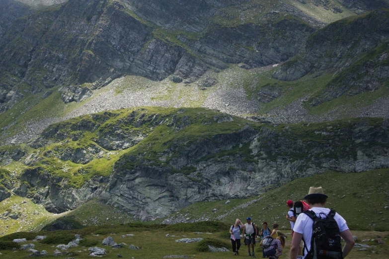 a group of people are hiking up a mountain