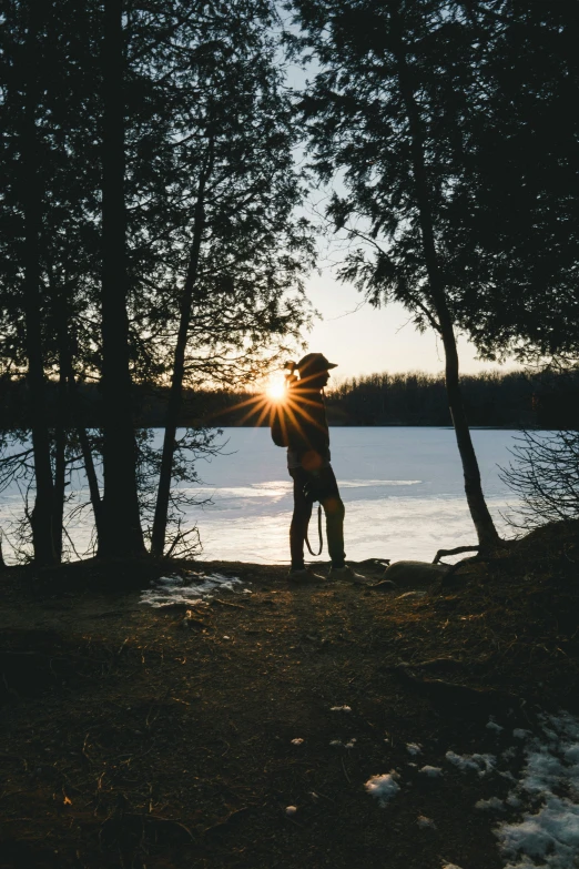 a man taking a po near some water