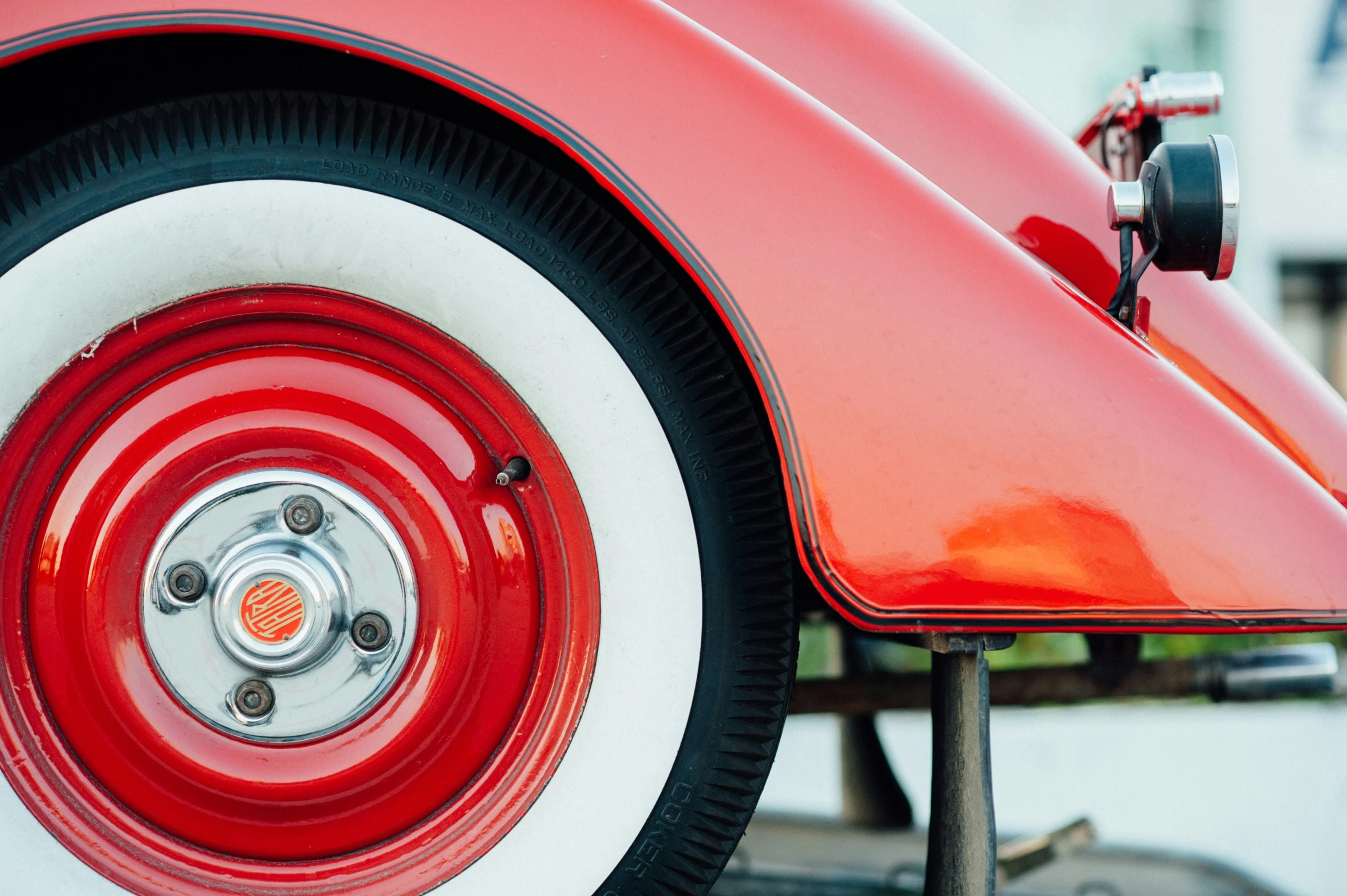 the side view of a red classic car