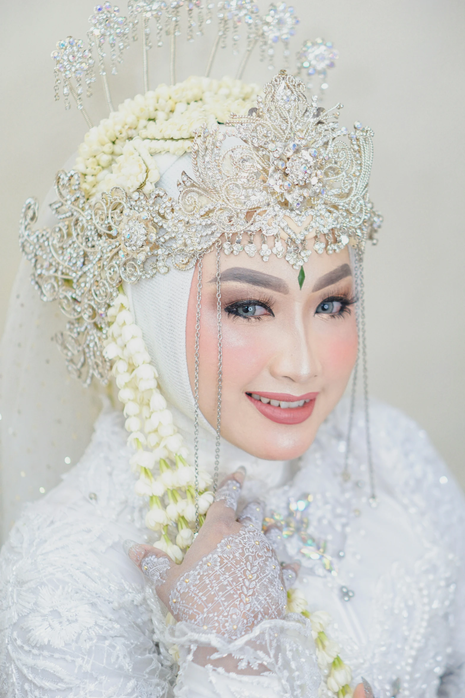 a woman with a veil and white flowered hair piece