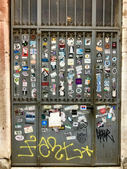 an iron gate that has various stickers on it