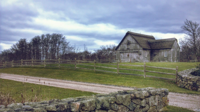 a large house on the side of a dirt road