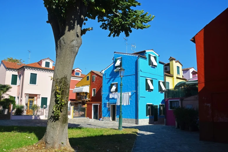 a blue building sitting in the middle of a neighborhood