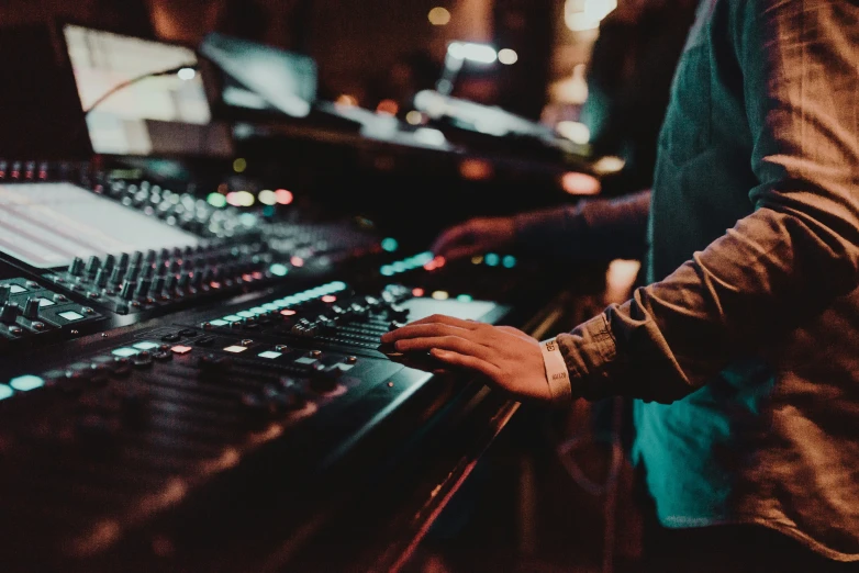 a man standing in front of a sound board