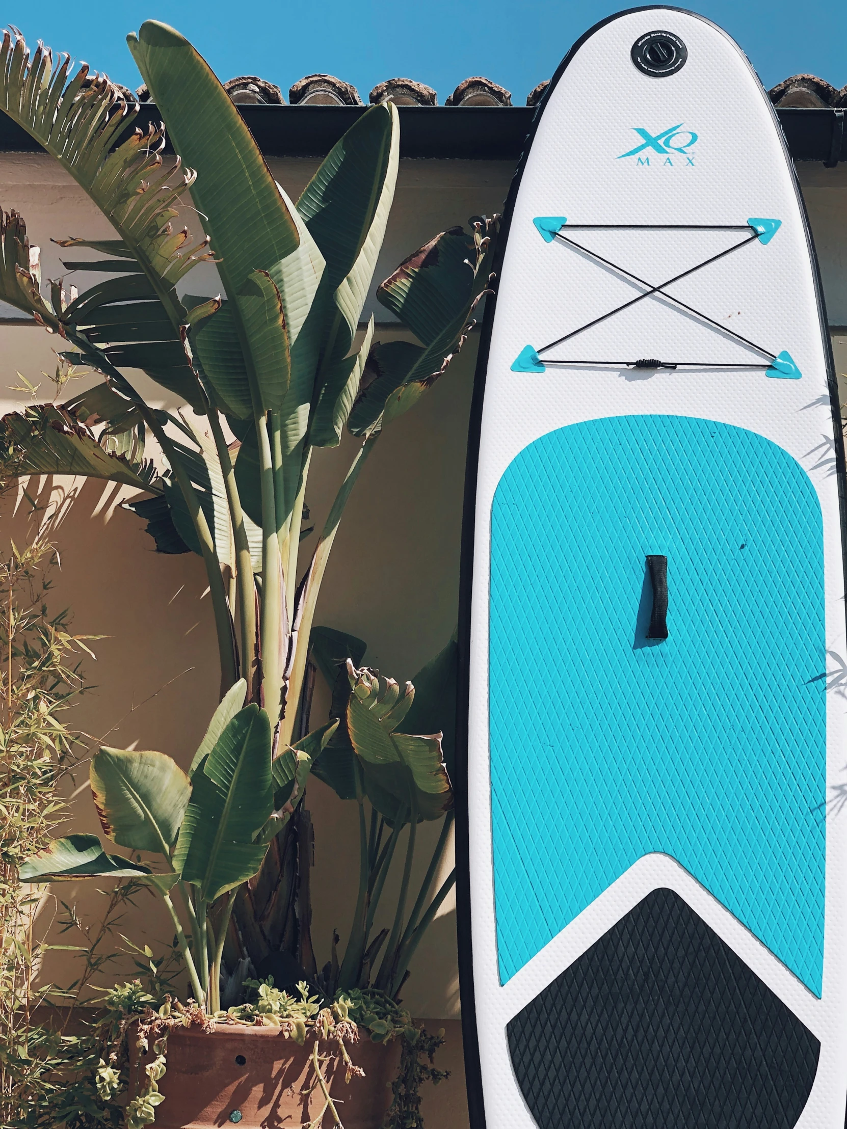 an image of a man standing in front of his surfboard