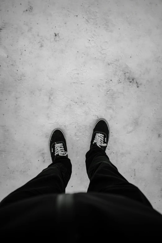 black and white pograph of man's feet with shoe laces