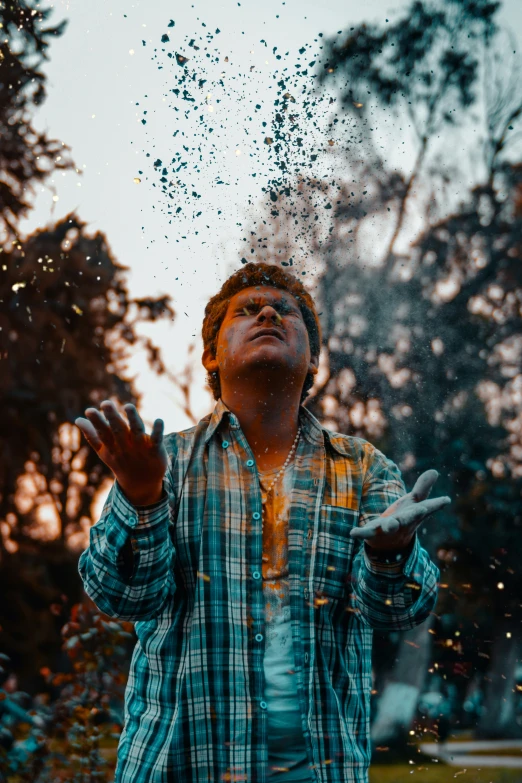 a man standing under rain pouring on his face