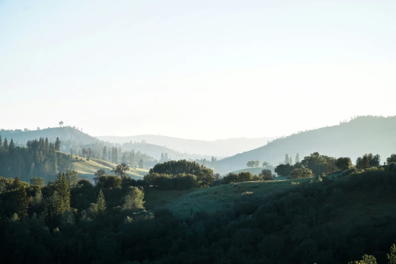 a hazy and peaceful mountain view is seen in this image