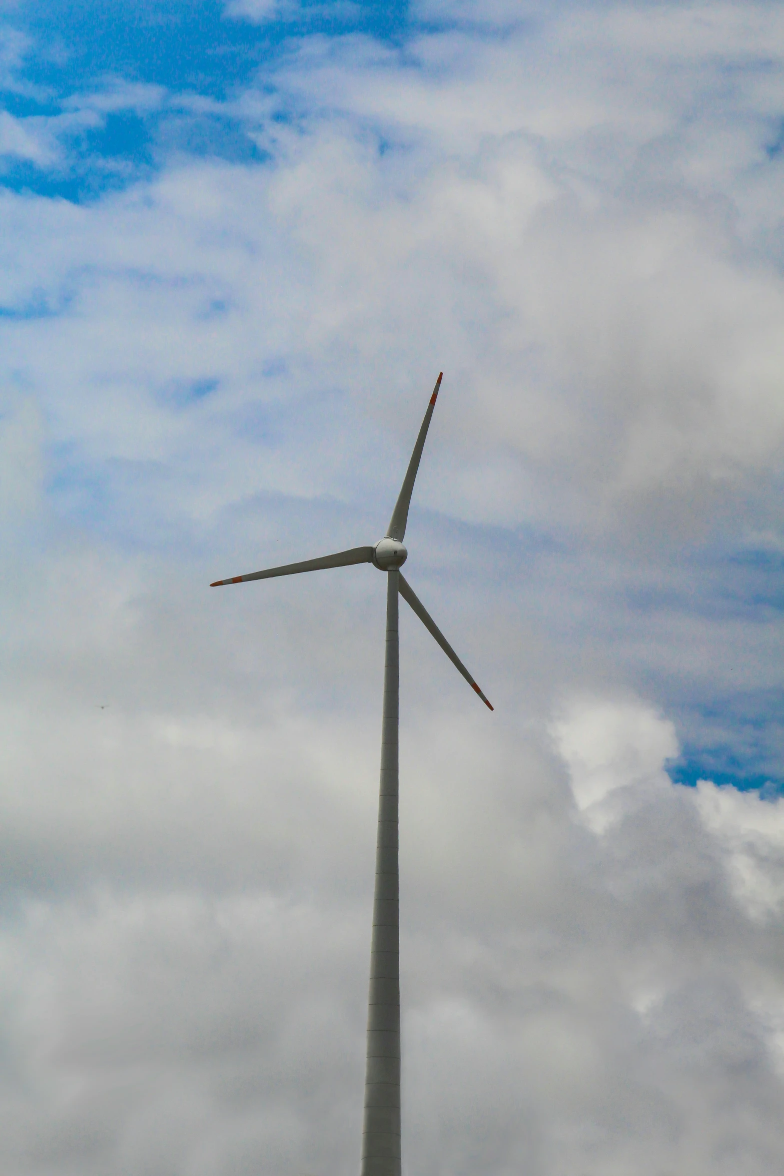 a wind turbine is shown against the blue sky