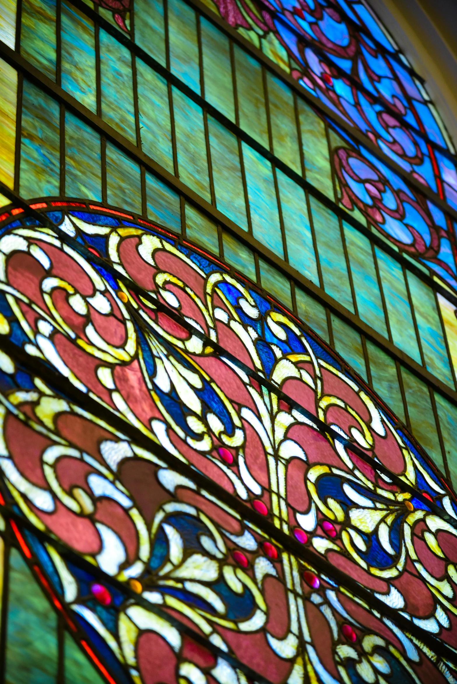 there is stained glass over the top and bottom of the building