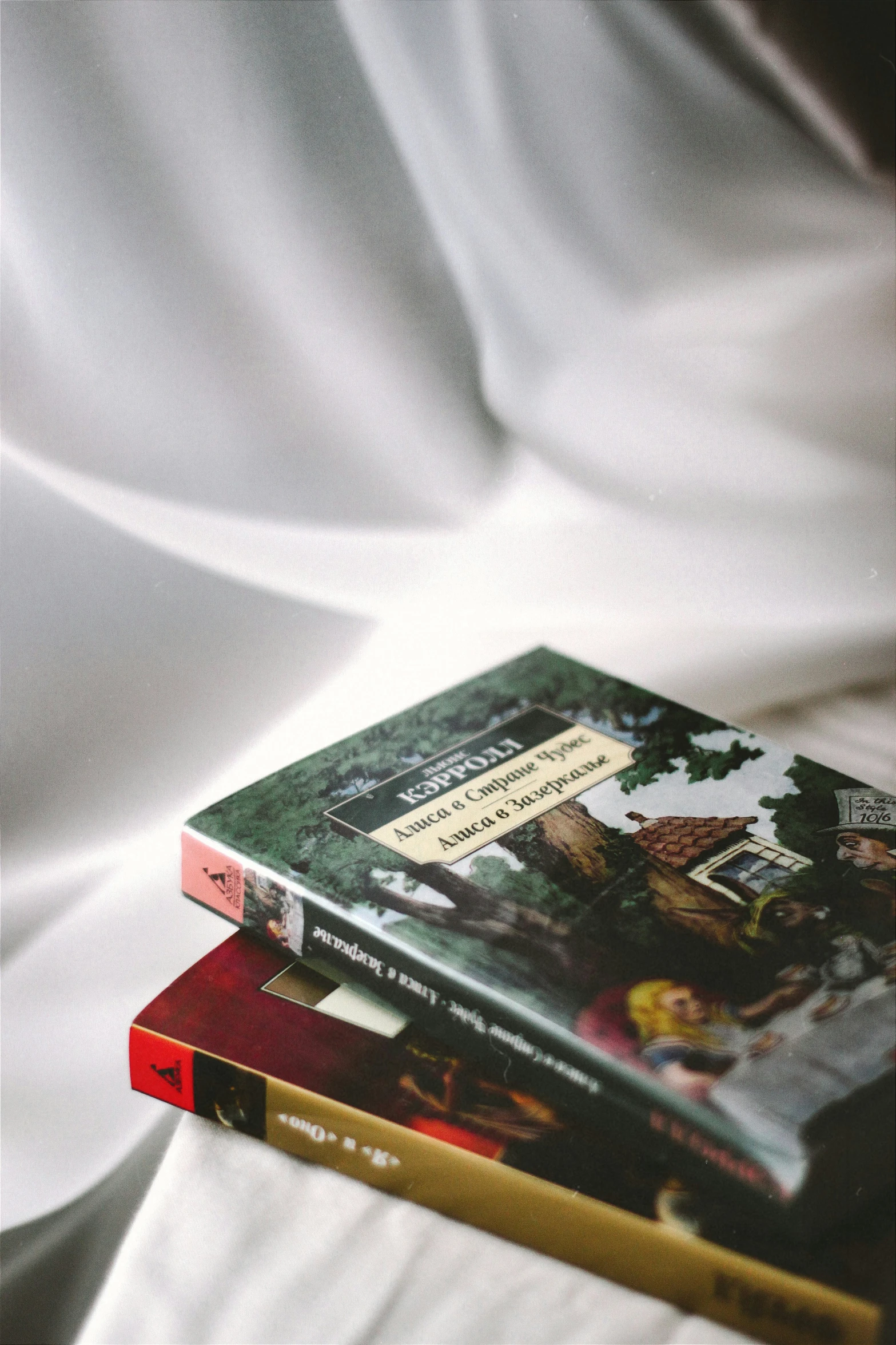 two books sitting on top of each other on a table