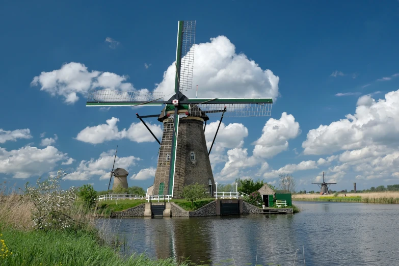 windmills in the water with a cloudy blue sky