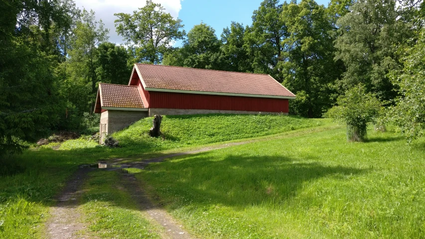 the cabin is located on the grass near the trees