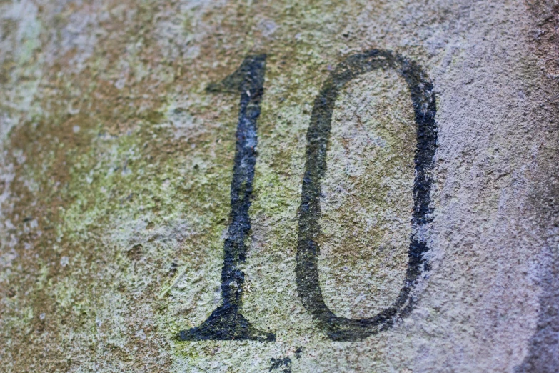 close up of the numbers 10 and 13 engraved in the sidewalk