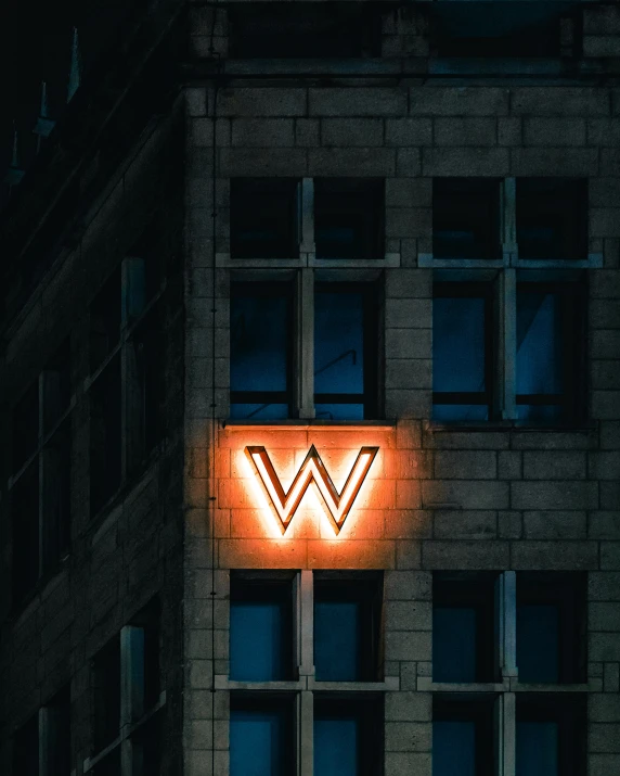 a very large bright neon sign mounted to the side of a building