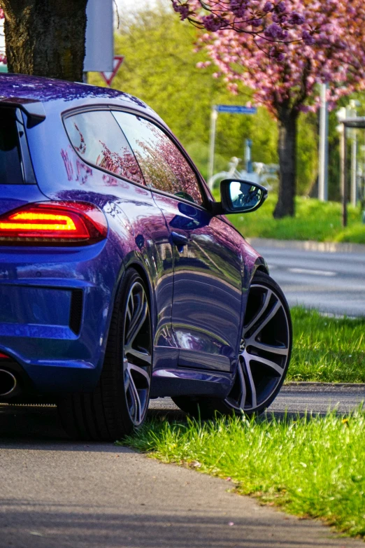 a purple car that is parked on the side of a road