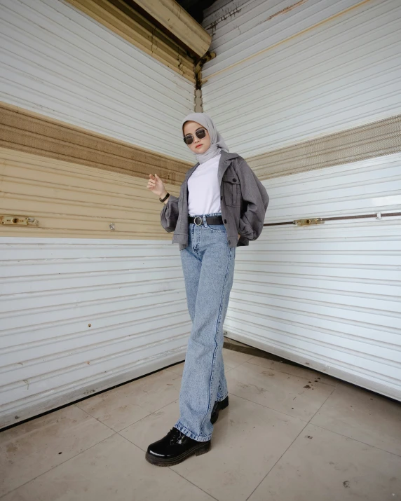 the woman is posing in front of the garage door