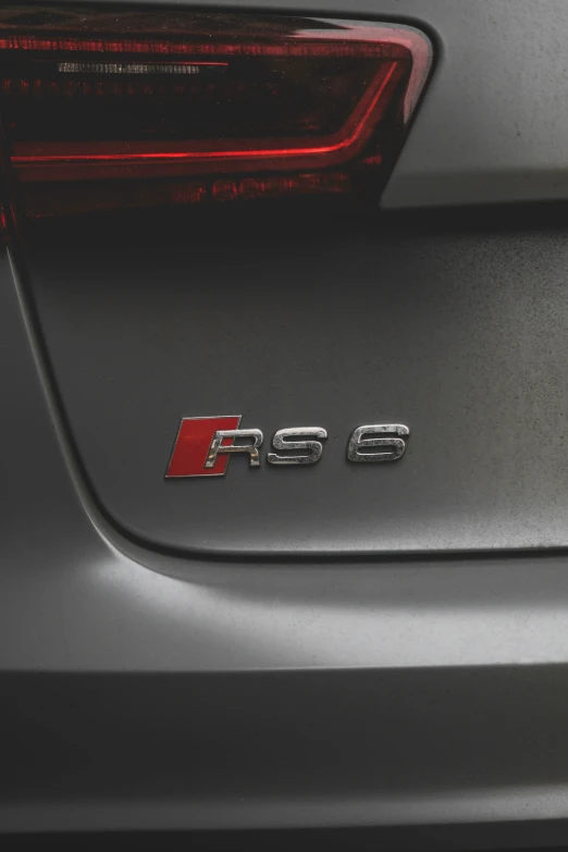 the rear end of a gray car that reads fris