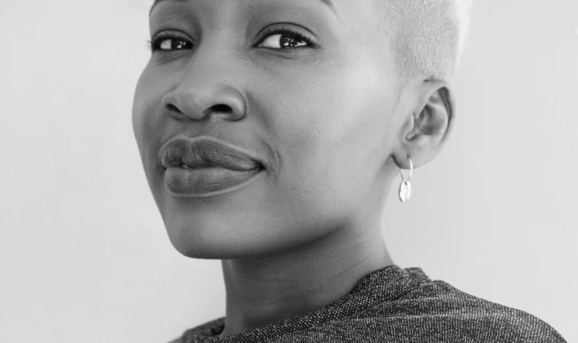 a woman is posing for the camera with shaved hair