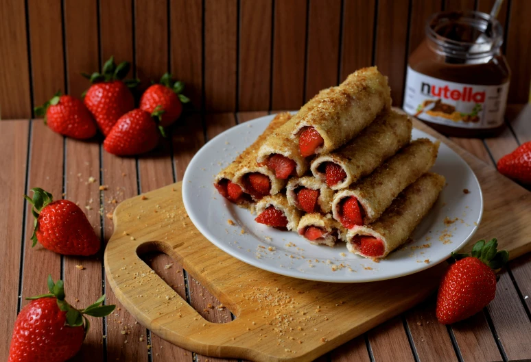 some strawberries on top of a plate with dipping sauce