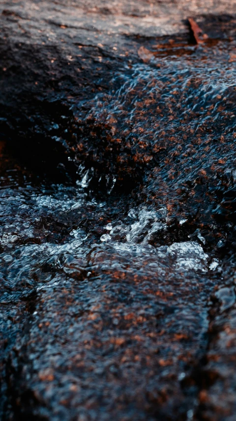 a water drop that is going through some rocks