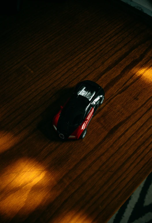 a remote control car sitting on top of a wooden floor