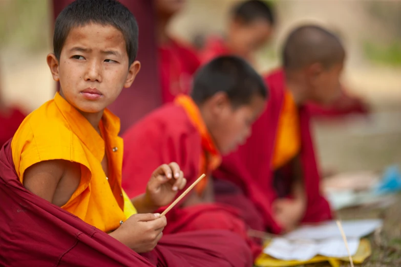 a group of monks seated and looking away