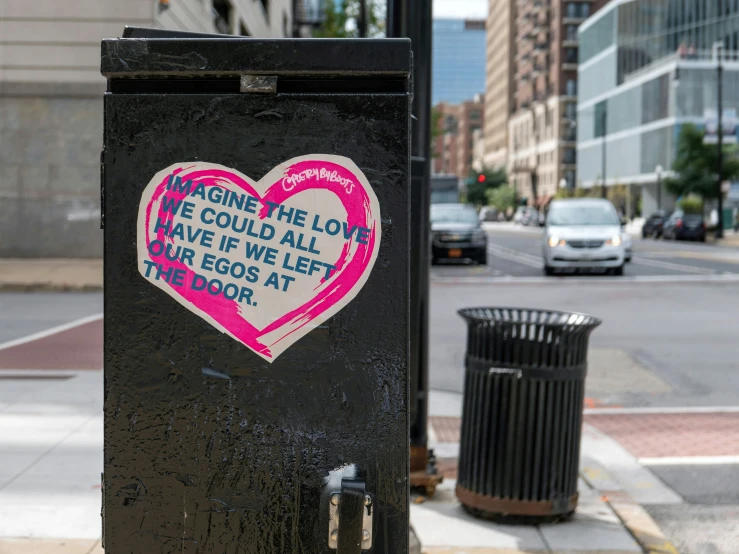a heart shaped graffiti on a city sidewalk