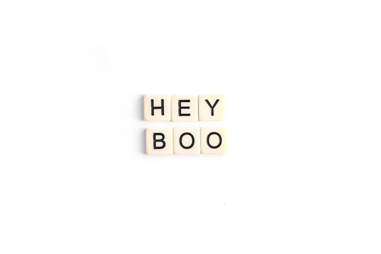 the words hey boo spelled with scrabble blocks