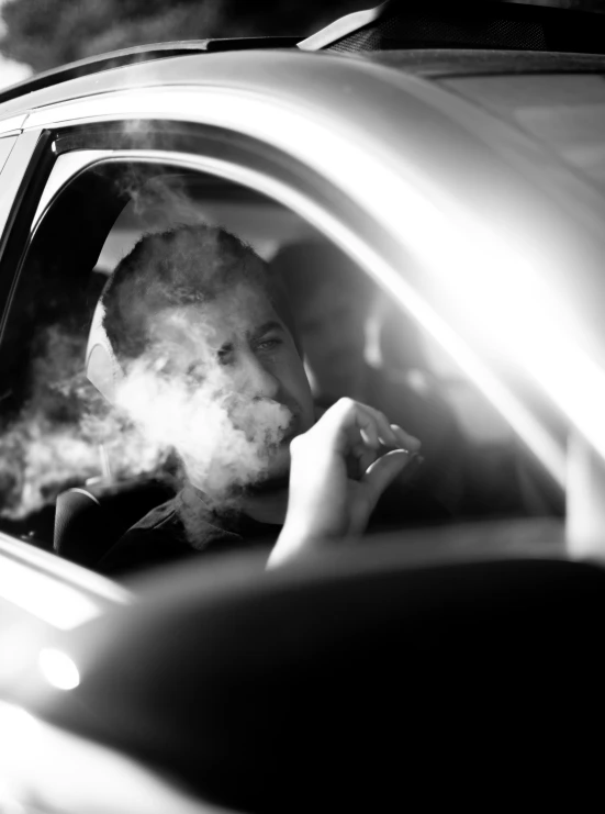 a car has its door open showing a cigarette - smoking driver
