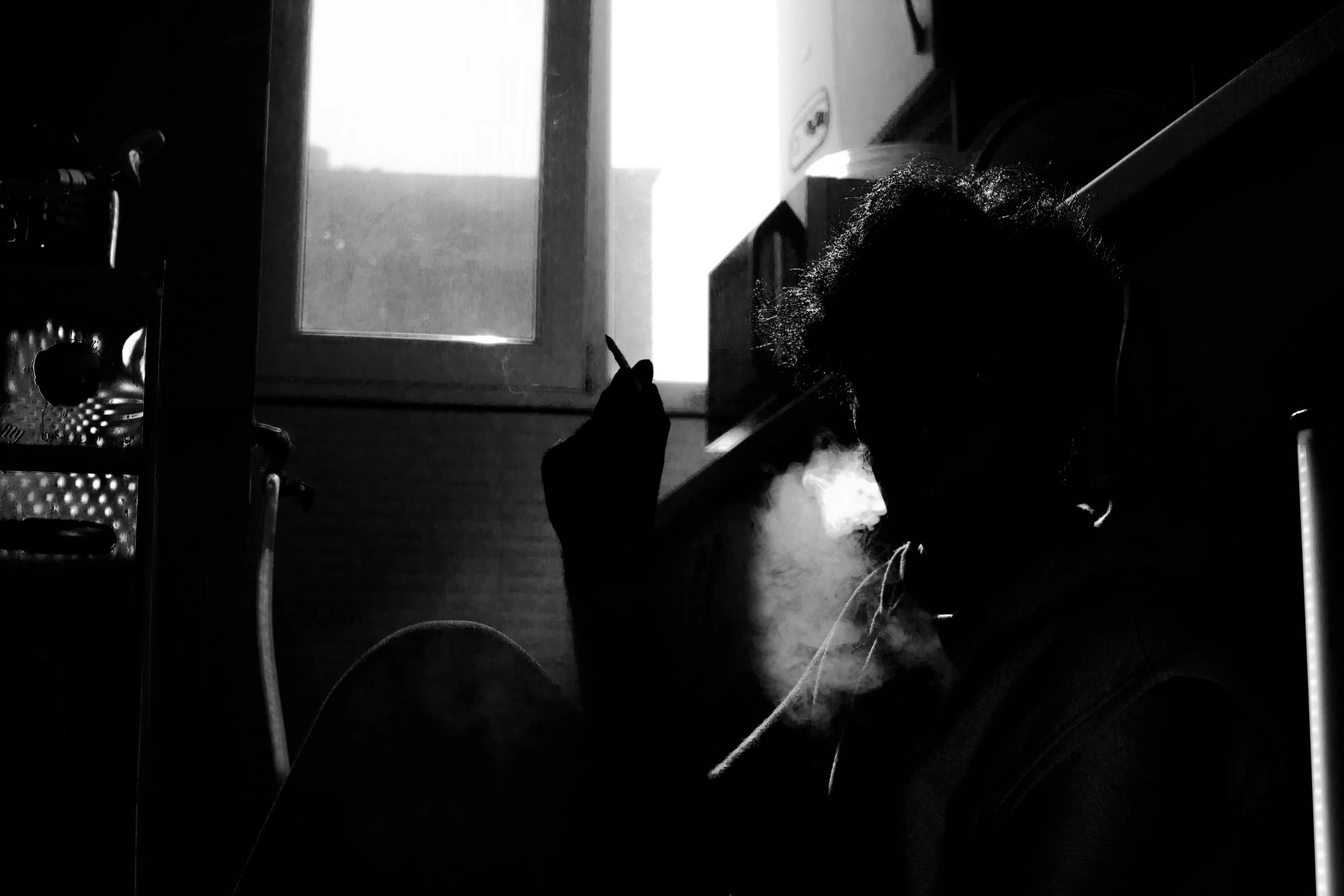 a woman smoking a cigarette in the dark