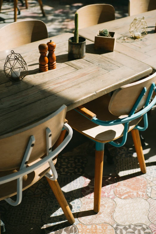 a wooden dining table with two chairs and an odd table top