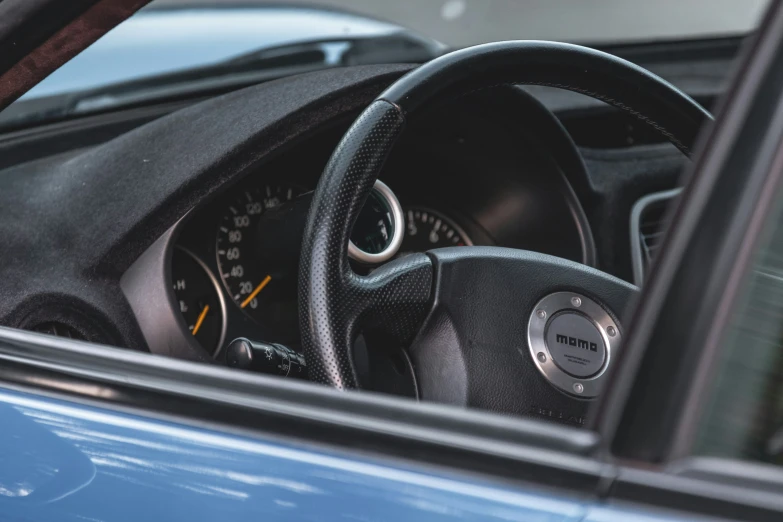 this is an automobile steering wheel with a view of the driver's dashboard