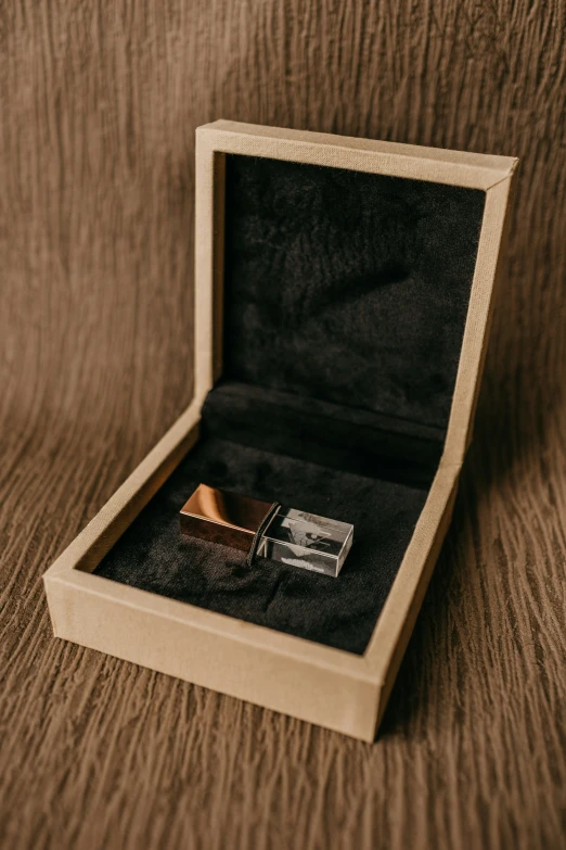 a wooden watch box with an open watch inside