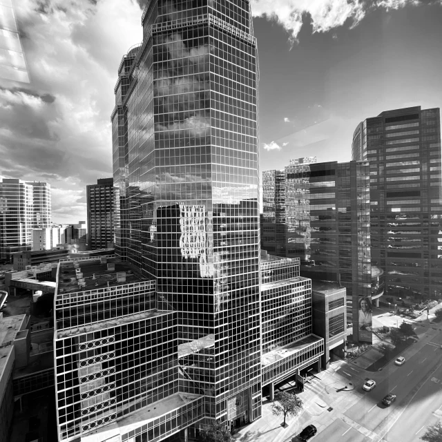 a black and white po of a modern building in a large city