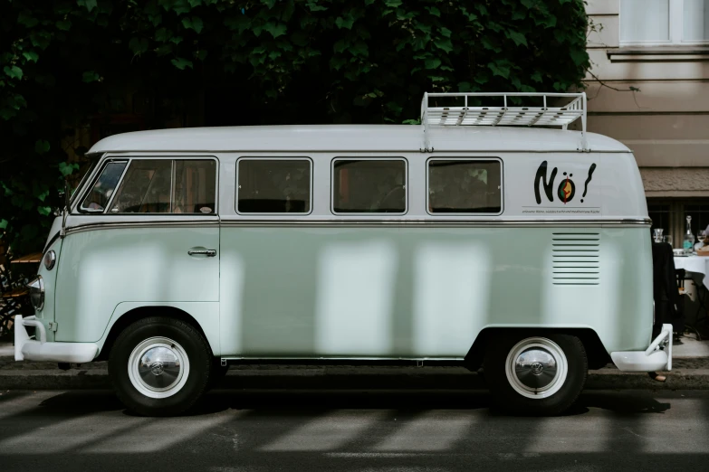 a classic vw bus parked on the side of a street