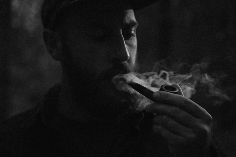 a man in a hat eating soing with smoke coming out of his mouth