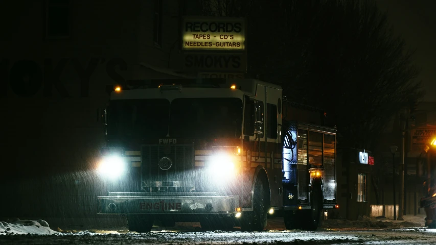 a large black bus on a city street