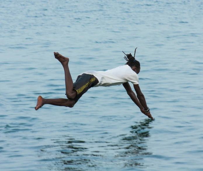 a person jumping in the air above water