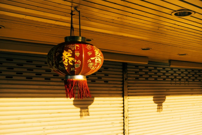 two lamps hanging over an awning and side walk