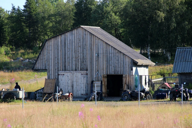 a barn with several bikes parked on the side of it