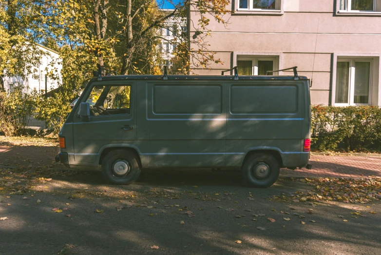 a gray van parked in front of a building