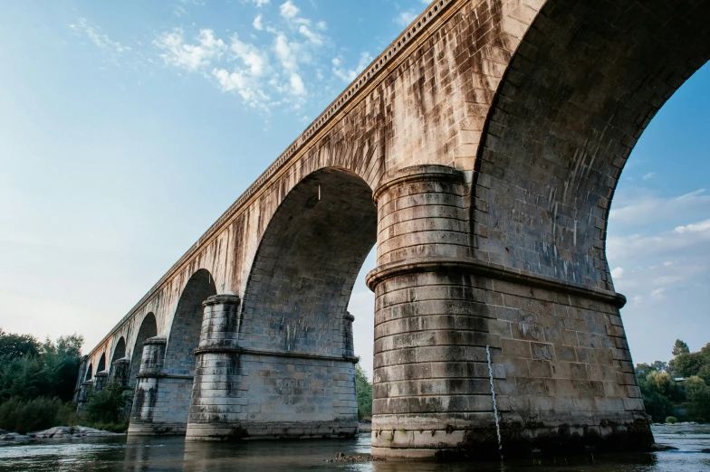 a bridge with two pillars and an arch